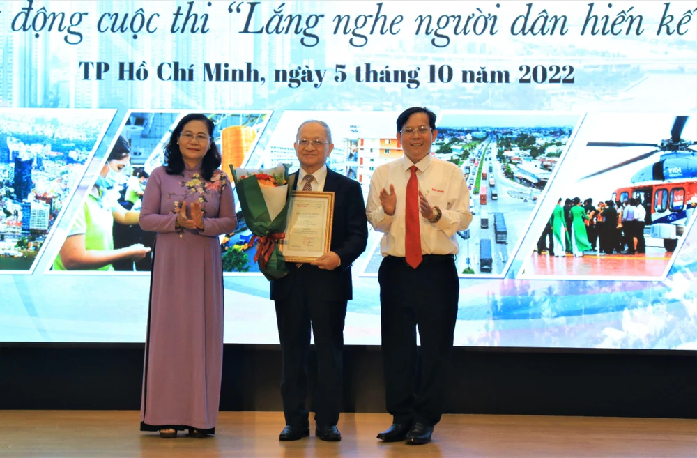 Bà Nguyễn Thị Lệ, Chủ tịch HĐND TP.HCM và ông Tô Đình Tuân, Tổng Biên tập báo Người Lao Động, trao giải nhất cho tác giả Lê Đăng Doanh. Ảnh: VÕ THƠ