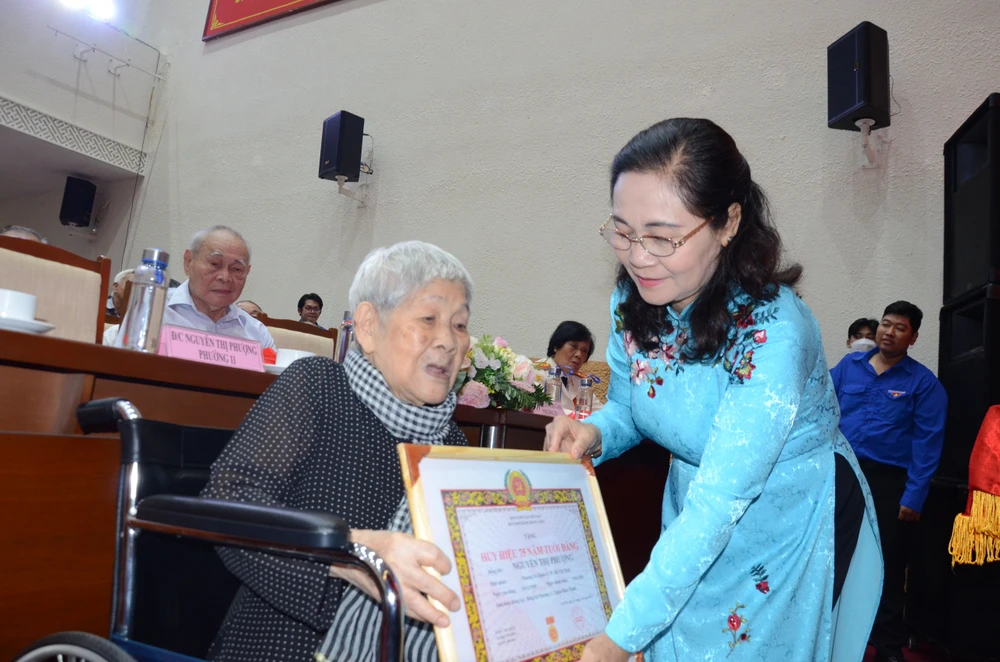 Bà Nguyễn Thị Lệ, Phó Bí thư Thành ủy TP.HCM, Chủ tịch HĐND TP.HCM trao huy hiệu Đảng cho đảng viên cao tuổi quận Bình Thạnh. Ảnh: NGUYỄN YÊN