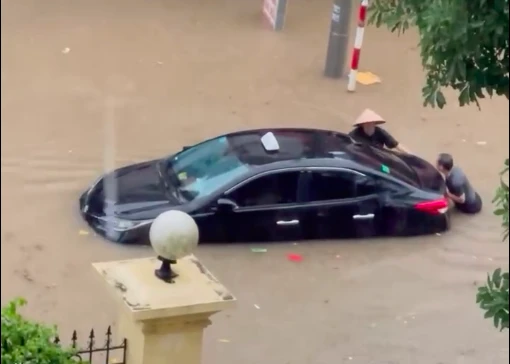 Tuyên Quang Người dân đẩy xe ô tô bị ngập trong biển nước.png