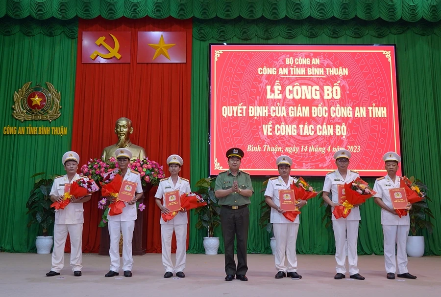 Đại tá Trần Văn Mười trao các quyết định điều động, bổ nhiệm và tặng hoa chúc mừng. Ảnh NHƯ Ý.