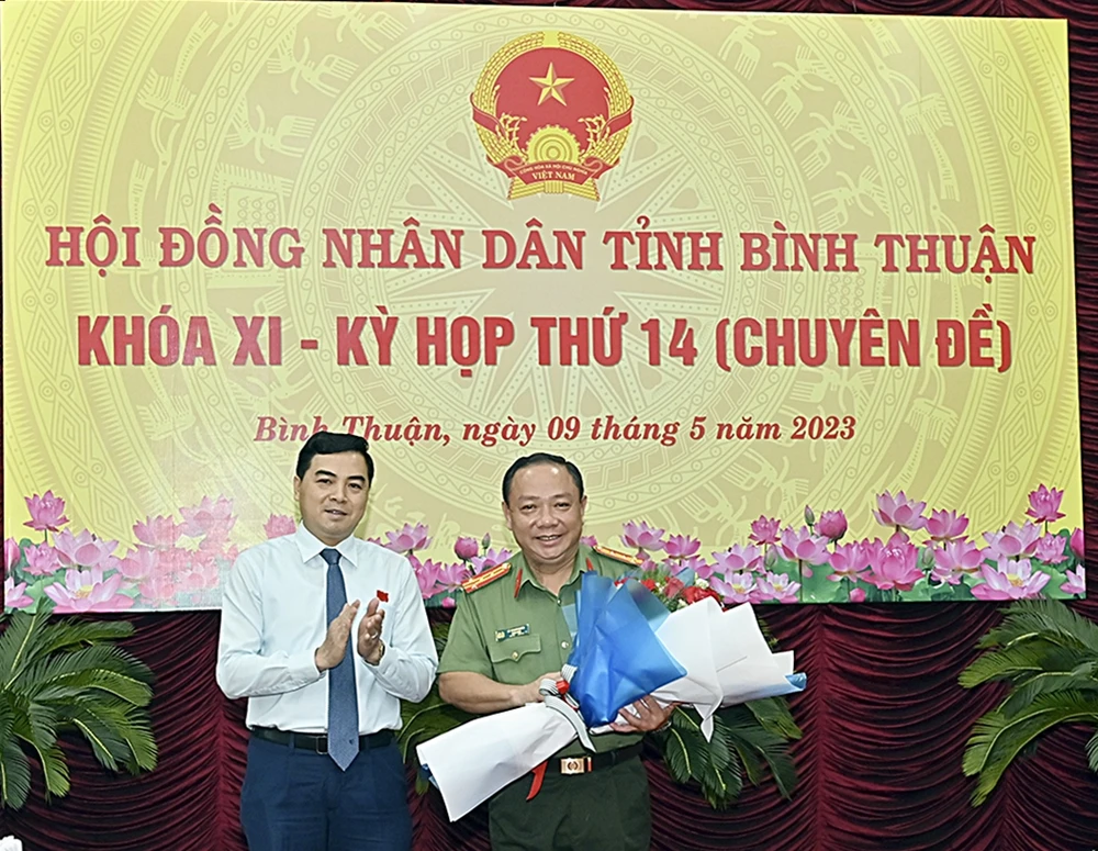 Ông Nguyễn Hoài Anh (trái) Chủ tịch HĐND tỉnh tặng hoa chúc mừng Đại tá Lê Quang Nhân. Ảnh ĐH.