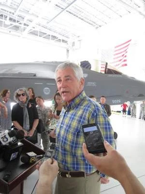 Defense Secretary Chuck Hagel stands in front of an F-35 joint strike fighter as he talks to reporters inside a hangar at Eglin Air Force Base in Florida.