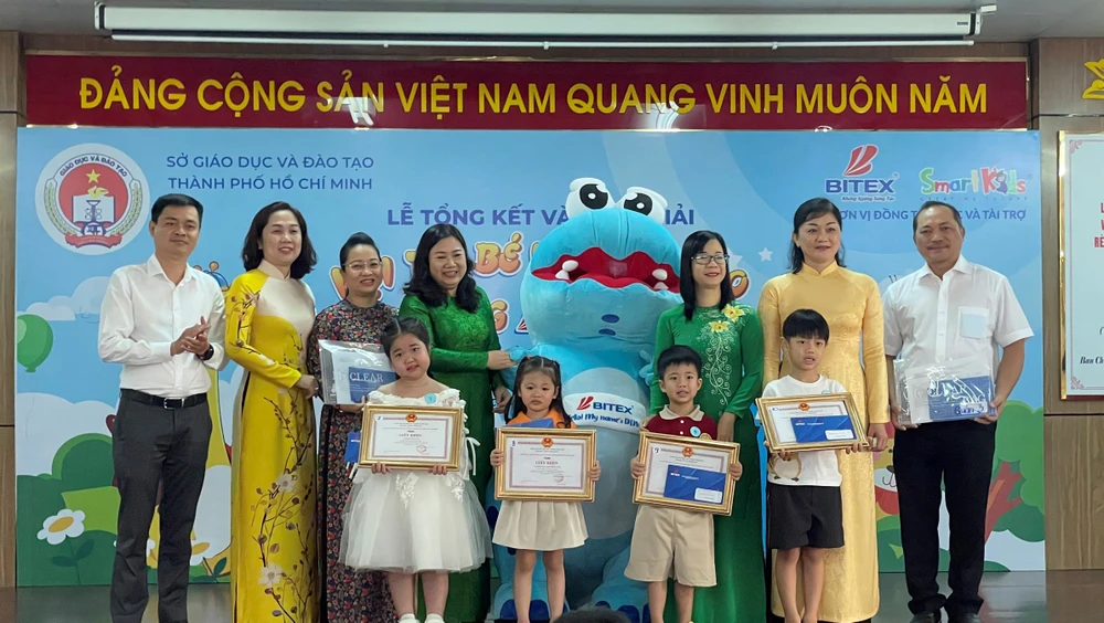 Bà Lương Thị Hồng Điệp (áo dài xanh, thứ tư từ trái qua) Trường phòng Giáo dục Mầm non, Sở GD&amp;ĐT TP.HCM trao giải cho các em. Ảnh: TH