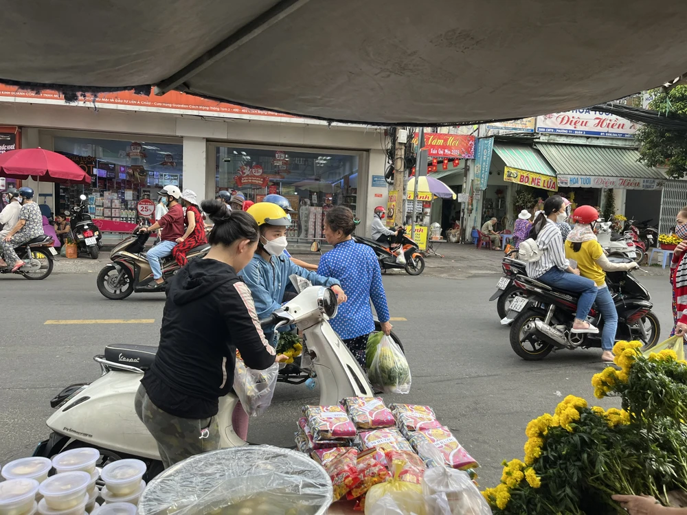 Người dân chọn mua xôi chè, đồ cúng ở điểm bán lề đường, mặt tiền chợ Hòa Hưng