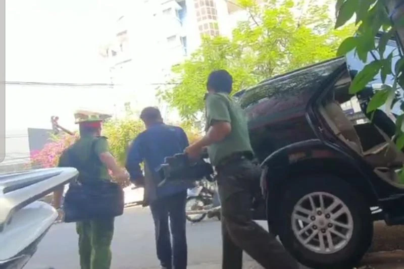 Lực lượng công an dẫn giải kế toán trưởng CDC Khánh Hòa đến trụ sở và tiến hành khám xét. Ảnh: HUỲNH HẢI