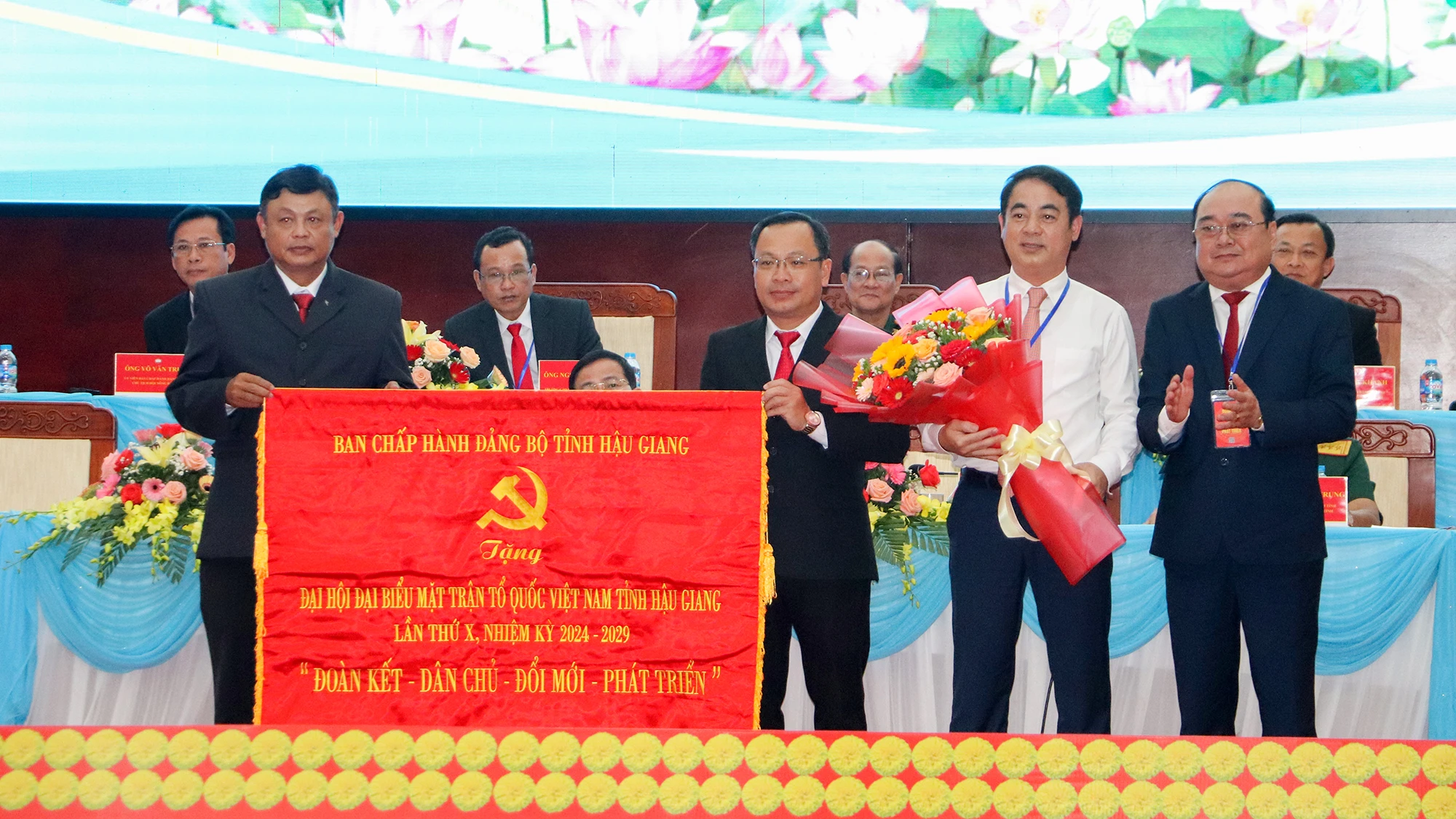 Thay mặt Ban Chấp hành Đảng bộ tỉnh Hậu Giang, ông Nghiêm Xuân Thành (thứ hai từ phải qua), Bí thư Tỉnh ủy Hậu Giang tặng Đại hội bức trướng. Ảnh: CHÂU ANH dai-hoi-mat-tran-to-quoc-tinh-hau-giang-11.jpg