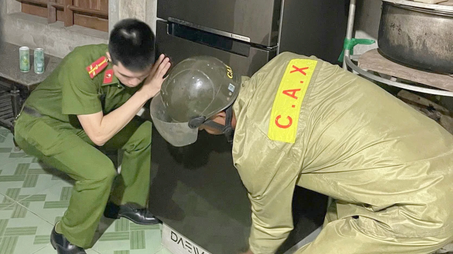 Công an giúp dân khiêng, kê tủ lạnh, tài sản lên cao tránh nước ngập.