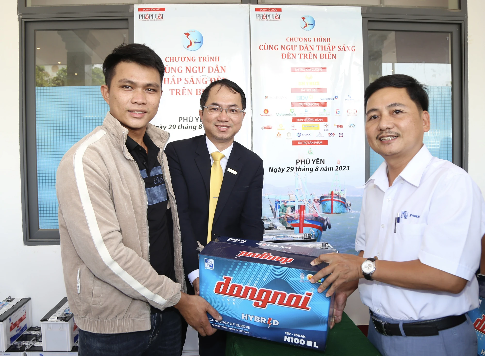 Ông Nguyễn Văn An (bìa phải), Giám đốc Công ty cổ phần Pin ắc quy miền Nam (PINACO) chi nhánh Đà Nẵng trao quà cho ngư dân.