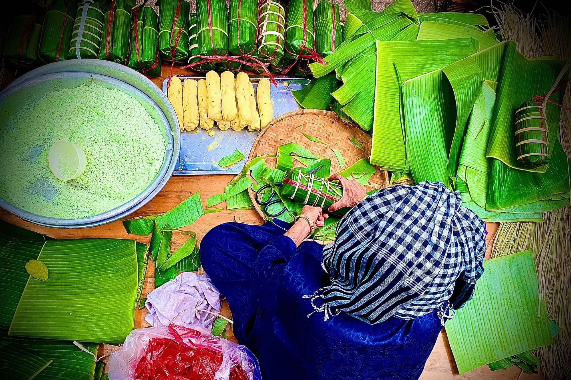 Dù tuổi đã cao nhưng cụ Ích vẫn đau đáu "giữ lửa" cho nồi bánh tét đã gầy dựng 40 năm qua, đôi tay cụ siết từng đòn bánh chắc nịch, thoăn thoắt. Ảnh: TÚ NGÂN Dù tuổi đã cao nhưng cụ Ích vẫn đau đáu "giữ lửa" cho nồi bánh tét đã gầy dựng 40 năm qua, đôi tay cụ siết từng đòn bánh chắc nịch, thoăn thoắt. Ảnh: TÚ NGÂN