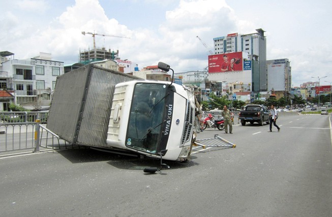 Xe tải lật nhào trên cầu vượt bằng thép