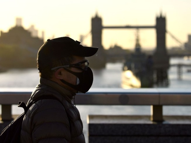 Người dân Anh đeo khẩu trang đi bộ gần khu vực cầu London, Anh (Ảnh chụp hồi tháng 2-2020). Ảnh: REUTERS