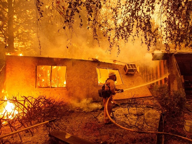 Một lính cứu hỏa tham gia nỗ lực dập tắt đám cháy ở hạt Butte (bang California) hồi tháng 11-2018. Ảnh: AFP
