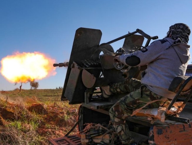 Một tay súng nổi dậy được Thổ Nhĩ Kỳ hậu thuẫn khai hỏa vào thị trấn Saraqib, Idlib hôm 26-2. Ảnh: AFP