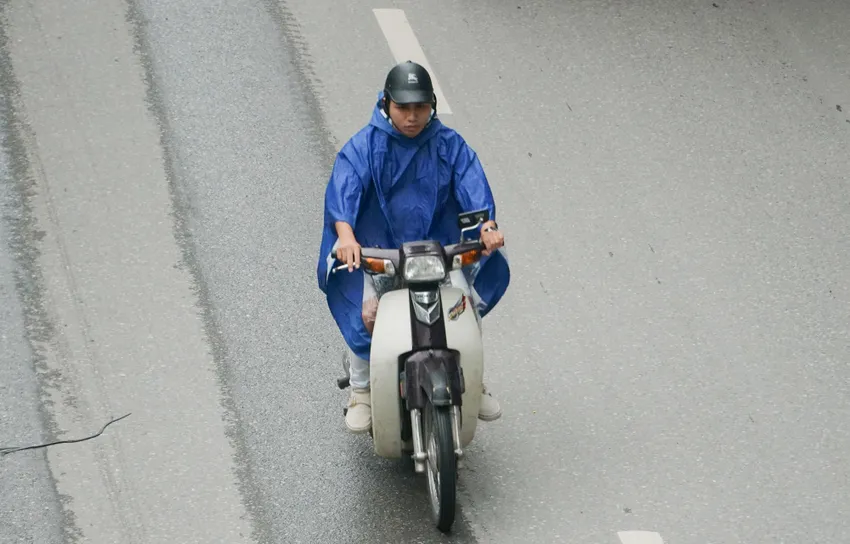 Có người mặc cả áo mưa để chống chọi lại với thời tiết lạnh của Hà Nội. DSC02148.JPG