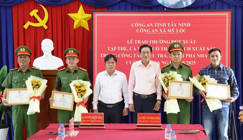 Lãnh đạo UBND xã Mỹ Lộc tặng giấy khen cho tập thể và cá nhân phá nhanh vụ cướp tài sản. Ảnh: CA khu vực biên giới.jpeg
