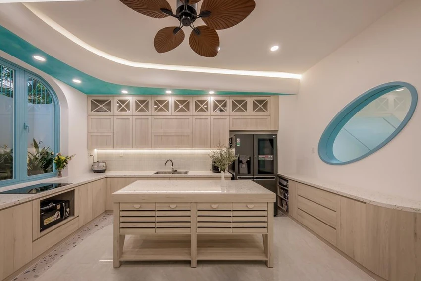 Bếp sử dụng màu gỗ sáng hòa cùng với sắc xanh tạo nên không gian nhẹ nhàng, ấm cúng.