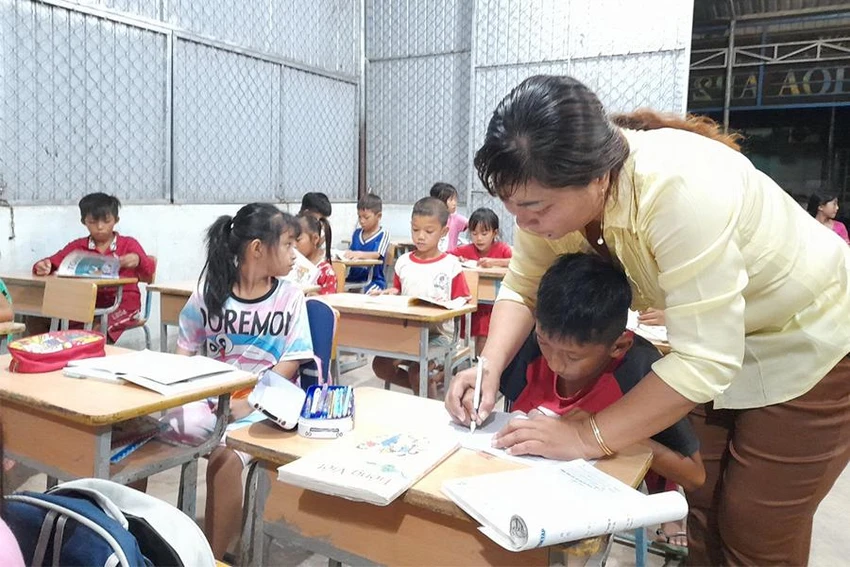 Cô Tuyền luôn tận tụy dạy các em nắn nót từng con chữ. Ảnh: HUỲNH DU Cô Tuyền luôn tận tụy dạy các em nắn nót từng con chữ. Ảnh: HUỲNH DU
