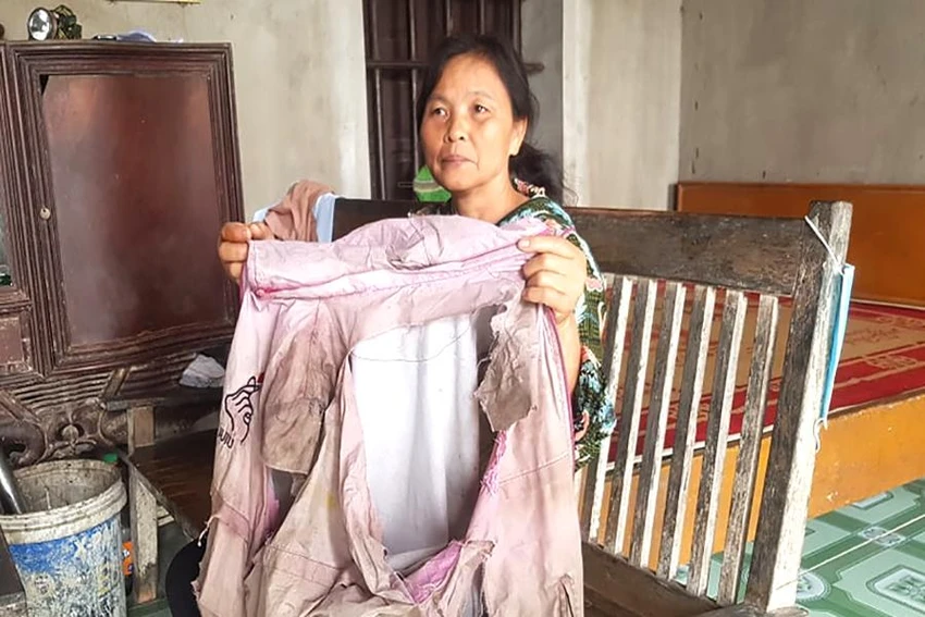 Chị Hẹn kể về chiếc áo bị rách sau nhiều giờ lội suối đi xuyên rừng để tìm lối ra. Ảnh: Đ.T Chị Hẹn kể về chiếc áo bị rách sau nhiều giờ lội suối đi xuyên rừng để tìm lối ra. Ảnh: Đ.T