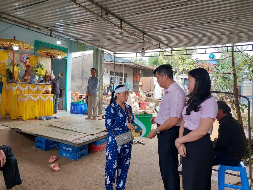 Ông Đoàn Ngọc Chung, Giám đốc Chi nhánh NHCSXH TP Đà Nẵng và lãnh đạo công đoàn cơ sở thăm hỏi gia đình có người mất trong mưa lũ vào tối 14-10.