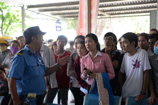 Bảo vệ hướng dẫn người dân xếp hàng chờ lấy số thứ tự - Ảnh: Hữu Khoa Bảo vệ hướng dẫn người dân xếp hàng chờ bắt số thứ tự. Ảnh: Hữu Khoa