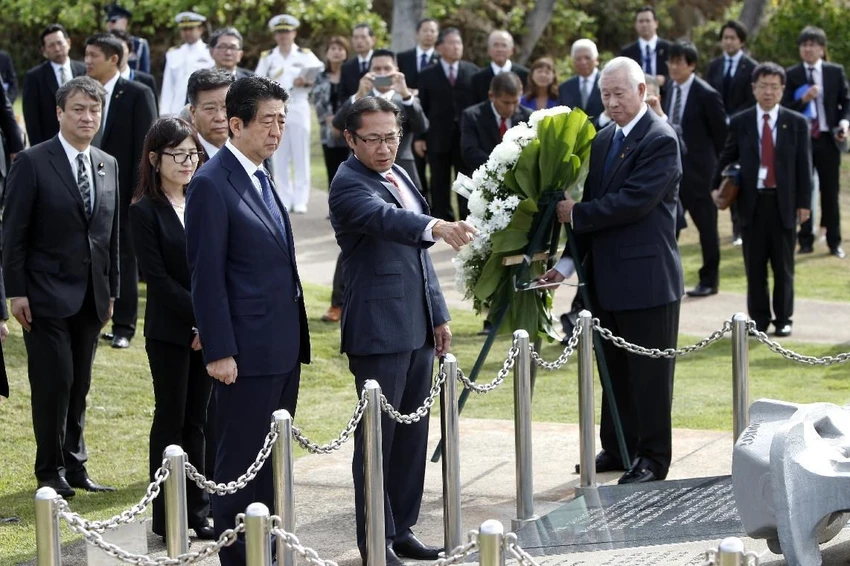 Thủ tướng Nhật Bản đến Hawaii thăm Trân Châu Cảng ảnh 1 Thủ tướng Nhật Shinzo Abe (thứ ba từ trái sang) đặt vòng hoa tại đài tưởng niệm Ehime Maru ngày 26-12. Ảnh: AP