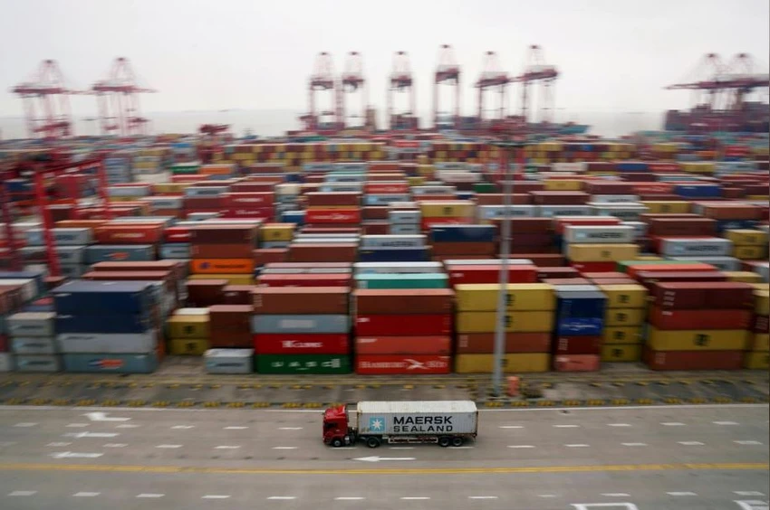 Xe tải và container hàng tại cảng nước sâu Yangshan ở Thượng Hải (Trung Quốc), ngày 24-4. Ảnh: REUTERS