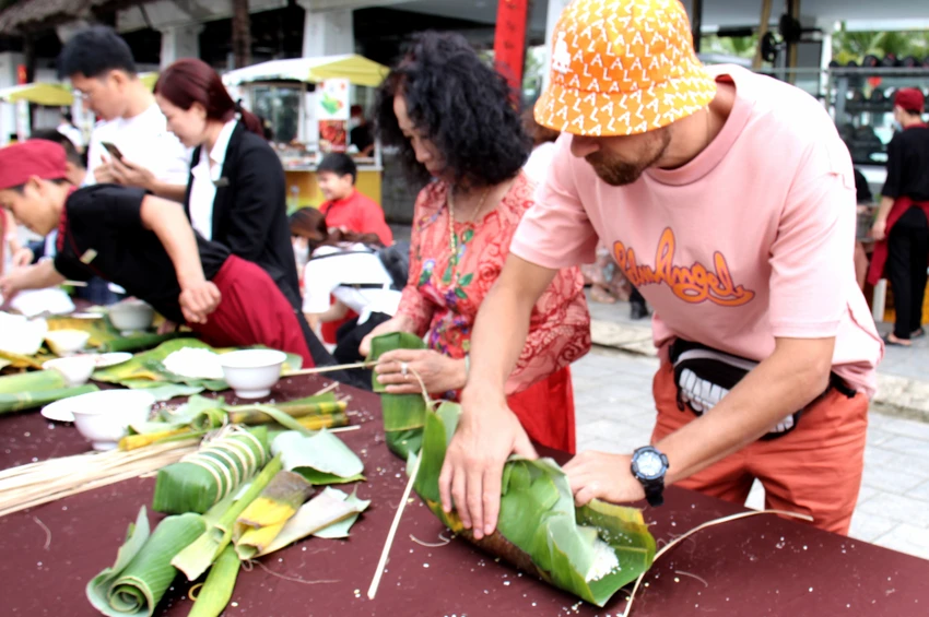 Khách Tây hòa hứng trải nghiệm gói bánh tét. Ảnh: CHU VÂN. Khách Tây hòa hứng trải nghiệm gói bánh tét. Ảnh: CHU VÂN.