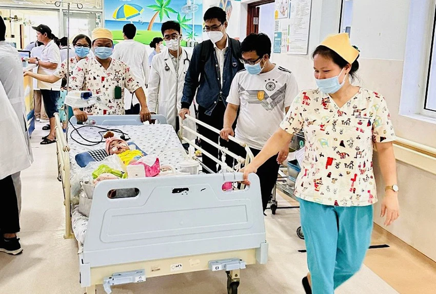 Các bác sĩ đưa bé C ra xe để về thở máy tại nhà. Ảnh: THẢO PHƯƠNG Các bác sĩ đưa bé C ra xe để về thở máy tại nhà. Ảnh: THẢO PHƯƠNG