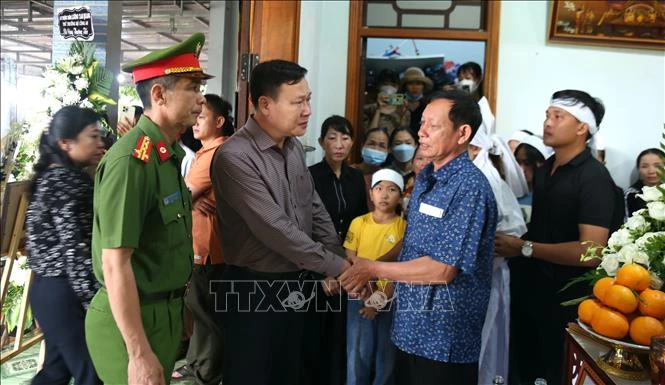 Phó Chủ tịch Hội đồng nhân dân tỉnh Đắk Lắk Trần Phú Hùng, Phó Giám đốc Công an tỉnh Trần Bình Hưng chia sẻ sự mất mát to lớn với gia đình Đại uý Hà Tuấn Anh, cán bộ Công an xã Ea Tiêu, huyện Cư Kuin. Ảnh: TTXVN