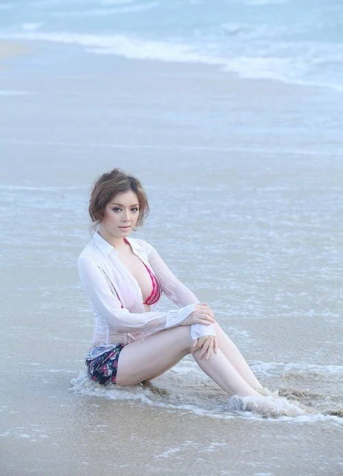 Lý Nhã Kỳ tỏ ra khá thận trọng khi đi biển. Cô khoác ngoài bộ bikini sắc màu nổi là chiếc áo sơ-mi trắng đơn giản. Bên trong lớp áo mỏng, người đẹp diện bikini màu hồng nổi bật. Tuy nhiên, cựu đại sứ vẫn rất nổi bật trên biển nhờ nước da trắng và vóc dáng đầy đặn. Nhập mô tả cho ảnh