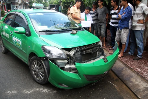Taxi bị bung dàn đầu sau khi tông hai xe máy. Ảnh:An Nhơn Taxi bị bung dàn đầu sau khi tông hai xe máy. Ảnh: An Nhơn