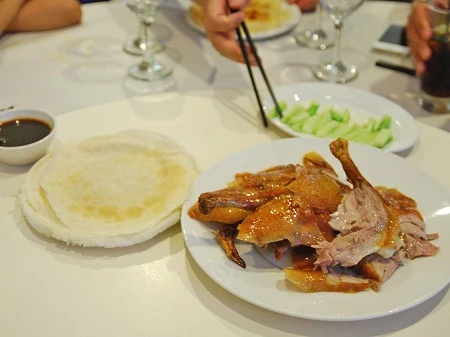 Thịt vịt quay ăn kèm bánh kẹp, hành tăm và nước tương ở Bắc Kinh, Trung Quốc.