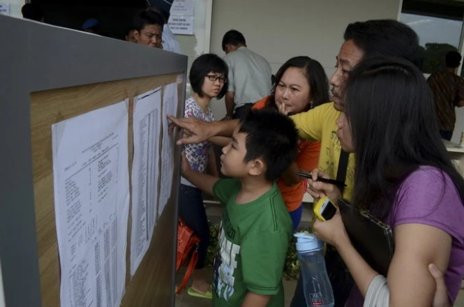 Tìm kiếm tên người thân trong danh sách - Ảnh: Reuters