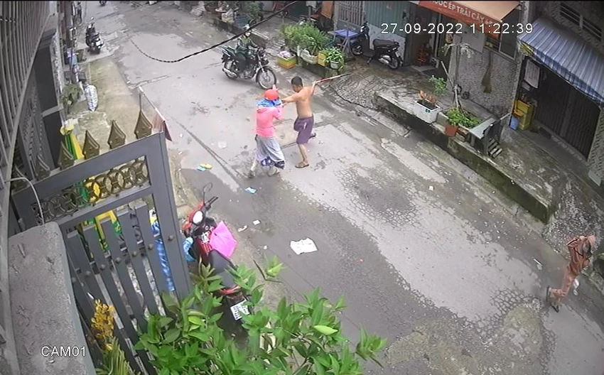 Người đàn ông tiếp tục đánh chị T thêm một gậy. Ảnh chụp từ clip