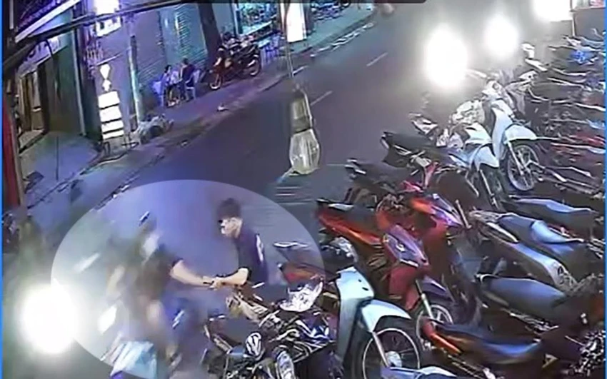Nam sinh viên đang đứng trông xe trong giờ làm thêm thì bị cướp giật điện thoại. Ảnh chụp từ clip Nam sinh viên đang đứng trông xe trong giờ làm thêm thì bị cướp giật điện thoại. Ảnh chụp từ clip