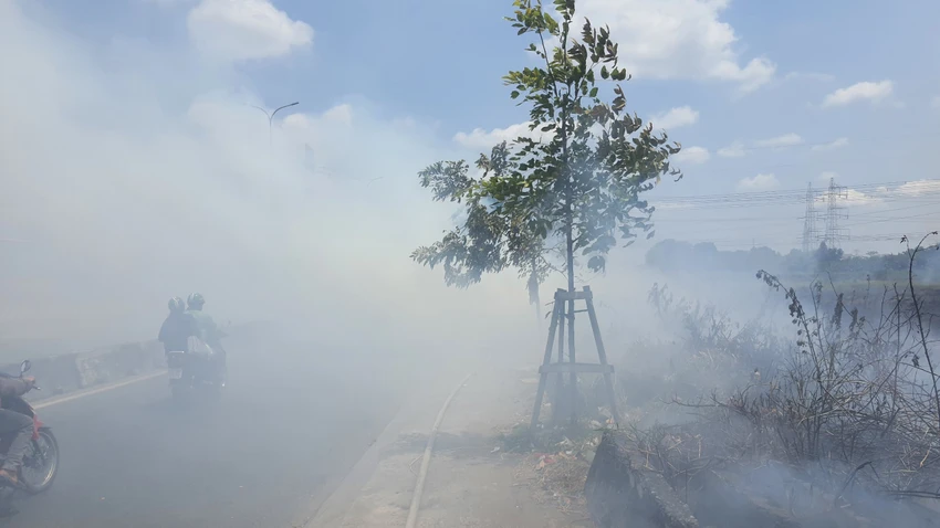 Khói lửa bốc cao và lan ra khiến nhiều phương tiện di chuyển trên quốc lộ 1 gặp khó khăn. Ảnh: HT Đốt rác làm cháy lan uy hiếp hàng chục căn nhà trọ ven Quốc lộ 1