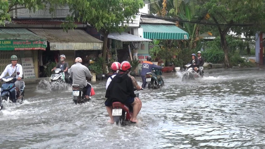 Người dân di chuyển vất vả trong nước lớn do triều cường. Ảnh: ĐC