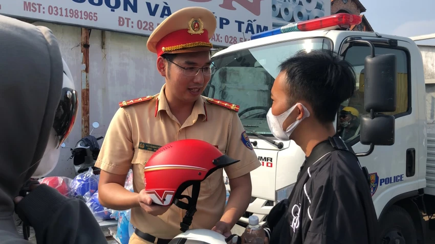 CSGT tặng nón bảo hiểm đạt chuẩn cho người dân. Ảnh: NY CSGT tặng nón bảo hiểm đạt chuẩn cho người dân