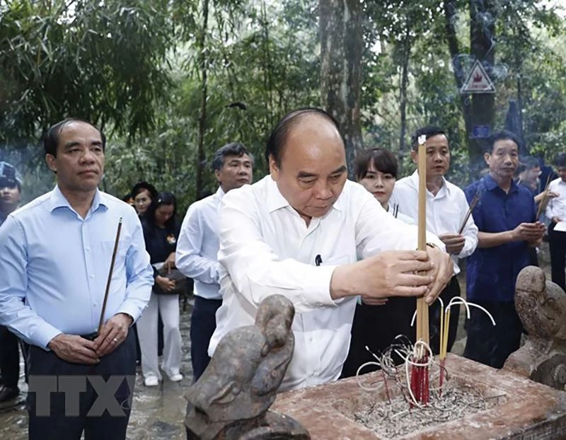 Chủ tịch nước Nguyễn Xuân Phúc cùng đoàn công tác dâng hương tưởng nhớ Chủ tịch Hồ Chí Minh tại Lán Nà Nưa trong Khu di tích lịch sử Quốc gia đặc biệt Tân Trào. Ảnh: TTXVN