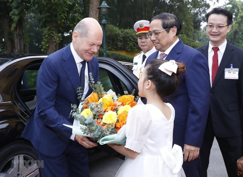 Thiếu nhi Hà Nội tặng hoa, chào mừng Thủ tướng Đức Olaf Scholz. Ảnh: TTXVN
