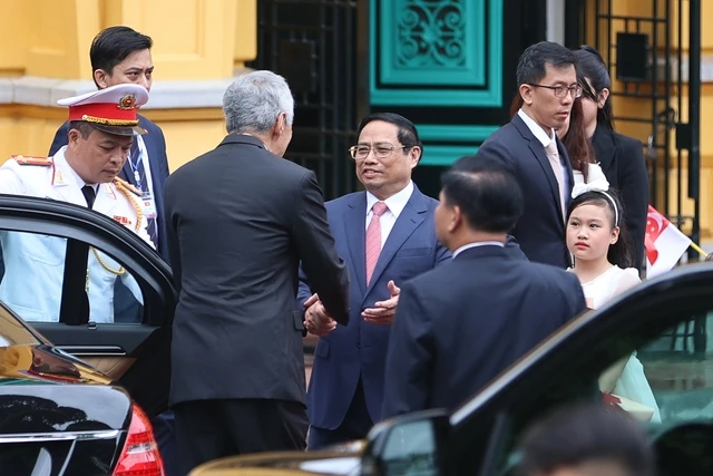 Thủ tướng Phạm Minh Chính đón Thủ tướng Singapore Lý Hiển Long tại xe. Ảnh: VGP Thủ tướng Phạm Minh Chính đón Thủ tướng Singapore Lý Hiển Long tại xe. Ảnh: VGP