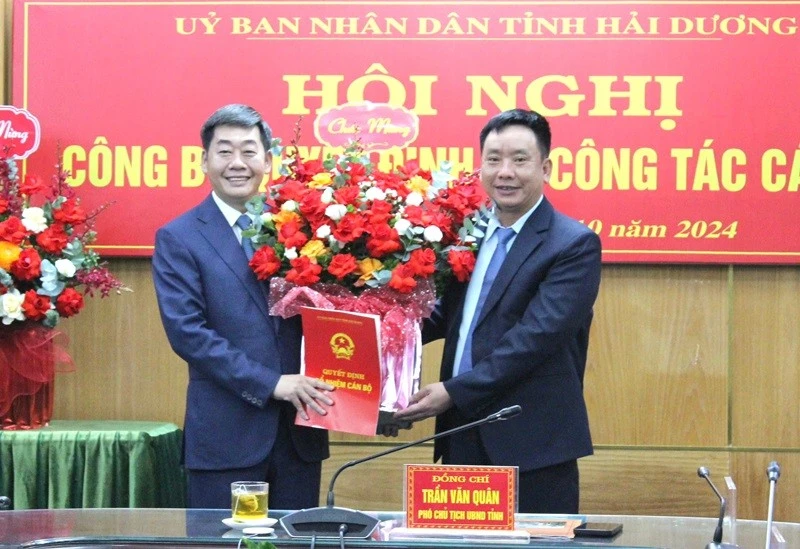 Ông Trần Văn Quân, Phó Chủ tịch UBND tỉnh Hải Dương (phải) trao quyết định tiếp nhận và bổ nhiệm giữ chức Phó Chánh Văn phòng UBND tỉnh cho ông Nguyễn Hoàng Long, Trưởng công an TP Chí Linh