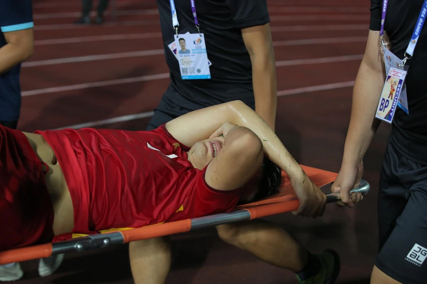 Văn Xuân rời sân trên cáng trong đau đớn. ẢNH: ANH PHƯƠNG Văn Xuân rời sân trên cáng trong đau đớn. ẢNH: ANH PHƯƠNG