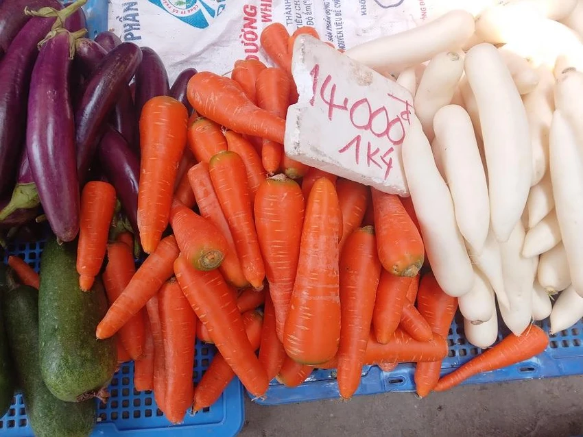 Tiểu thương cho biết cà rốt Đà Lạt đẹp mắt giá chỉ 14.000 đồng/kg. ẢNH: TÚ UYÊN Tiểu thương cho biết cà rốt Đà Lạt đẹp mắt giá chỉ 14.000 đồng/kg. ẢNH: TÚ UYÊN